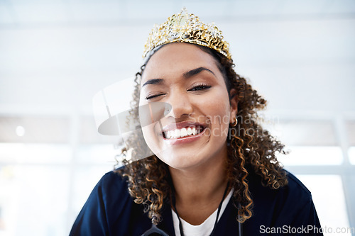 Image of Portrait, crown and wink with a nurse in a hospital for healthcare having fun or feeling playful. Medical, winner and comic with a female internship student winking in a clinic for promotion