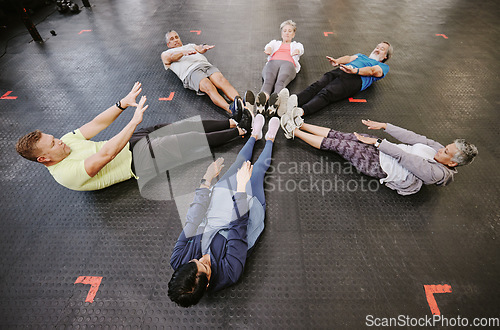 Image of Gym, fitness workout and group doing exercise for abdomen together in a health training class. Studio floor, stretching and sport of athlete group and friends with cardio, target goals and challenge