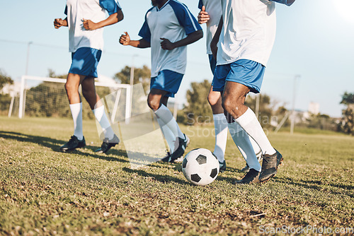 Image of Sports, soccer and team playing on the field at a game competition, league or championship. Fitness, football and male sport players running with a ball at an outdoor match on the soccer field.