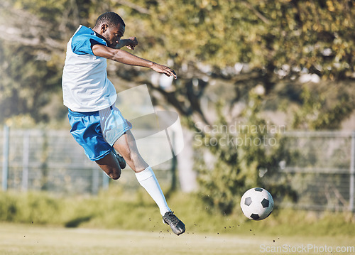 Image of Sports, soccer and man in action with ball playing game, training and exercise on outdoor field. Fitness, workout and male football player kicking, running and score goals, winning and competition