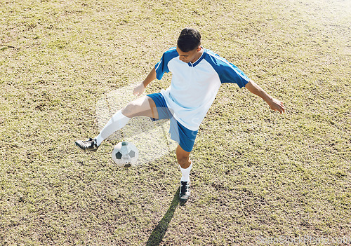 Image of Football, soccer ball and athlete doing sports cardio, training and exercise on a grass field. Kick, game and workout outdoor with fitness and running for wellness and health for game with energy