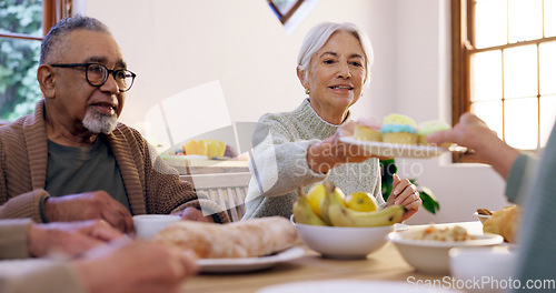 Image of Cup cake, tea party and group of senior people in the living room of a community home for a social. Friends, retirement or conversation with elderly men and women together in an apartment for a visit