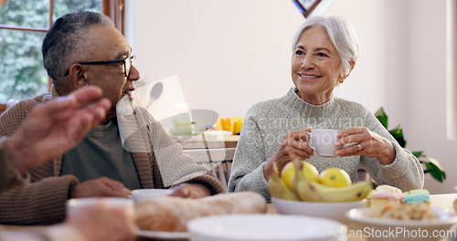 Image of Friends, tea party and a group of senior people in the living room of a community home for a social. Retirement, smile or conversation with elderly men and women together in an apartment for a visit