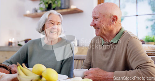 Image of Laughing, retirement and a senior couple drinking tea in the dining room of their home together in the morning. Smile, funny or conversation with an elderly man and woman in an apartment for romance