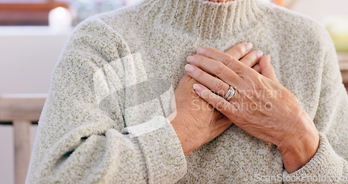 Image of Hands, breathing and heart attack with an elderly person in the dining room of a retirement home closeup. Healthcare, medical or emergency and a senior adult with chest pain for cardiac arrest