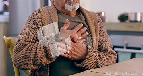 Image of Hands, breathing and heart attack with a senior person in the dining room of a retirement home closeup. Healthcare, medical or emergency and an elderly adult with chest pain for cardiac arrest