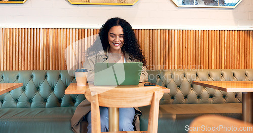 Image of Happy woman in coffee shop, typing on laptop and remote work, reading email or writing blog, article or search on technology. Computer, freelancer or copywriting in cafe, store or restaurant at table