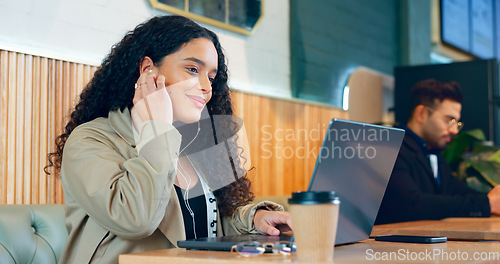 Image of Woman, music and laptop in coffee shop for remote work, research or networking for business with smile. Face, person and happiness with technology in cafe for copywriting, internet and freelancer