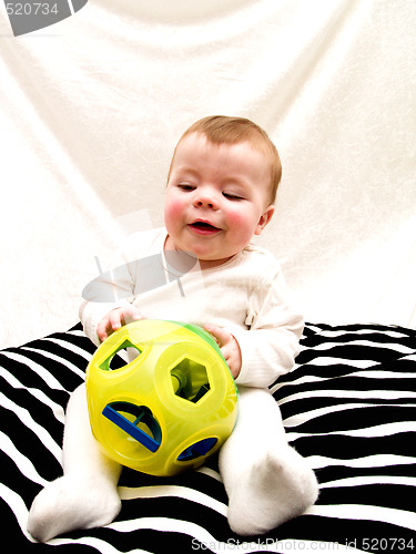 Image of Cute little baby boy playing with toy