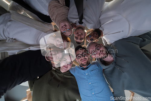 Image of In a modern office, a group of young business professionals is captured in a warm and embracing hug, reflecting the spirit of unity, collaboration, and shared success in their dynamic workplace.