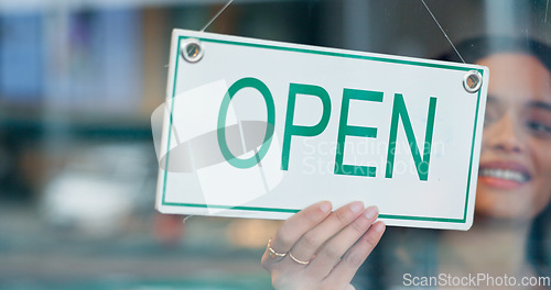 Image of Happy woman, small business or open sign on window in coffee shop or restaurant ready for service. Advertising, start or entrepreneur holding board, poster or welcome for message in diner or cafe