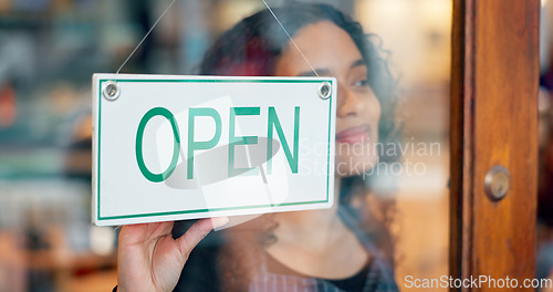 Image of Woman, small business or open sign on window in coffee shop or restaurant for service or advertising. Ready, start or entrepreneur holding board, poster or welcome for message in retail store or cafe