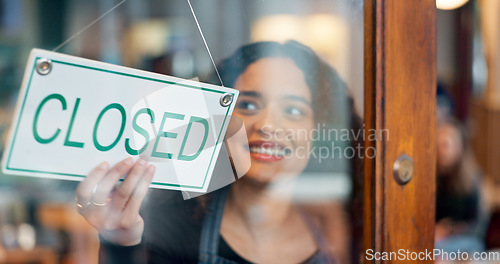 Image of Happy woman, small business or closed sign on window in coffee shop or restaurant for end of service. Closing time, smile or manager with board, poster or message in retail store or cafe for notice