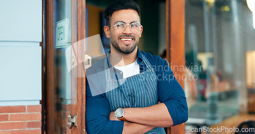 Image of Waiter, man and portrait with arms crossed or happy for service, welcome or server in coffee shop. Barista, person and face with smile for hospitality, career or confidence at entrance of restaurant