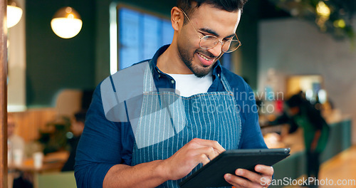 Image of Cafe, man and business owner on tablet for restaurant sales, online management or customer service reviews. Happy entrepreneur, waiter or barista typing on digital technology for coffee shop startup