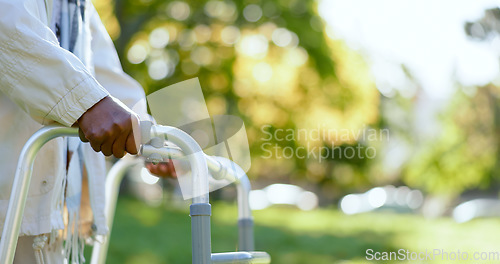 Image of Hands, walking frame and an elderly person in a garden outdoor in summer closeup during retirement. Wellness, rehabilitation or recovery and a senior adult with a disability in the park for peace