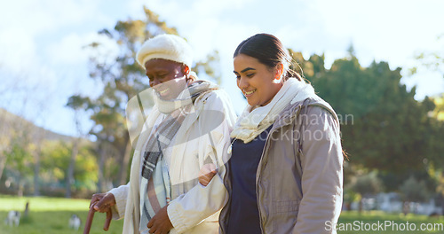 Image of Senior care, old woman with cane and nurse in park with support, help or trust at nursing home. Retirement healthcare, elderly person and happy caregiver walk and talk in garden together with smile.