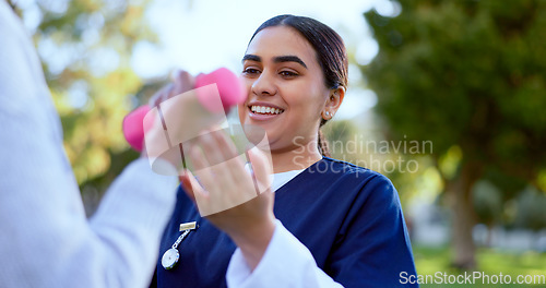 Image of Hands, caregiver and dumbbell outdoor for exercise, workout or fitness in a park with happiness. People, professional or nurse with weightlifting for physiotherapy, wellness and health in nature