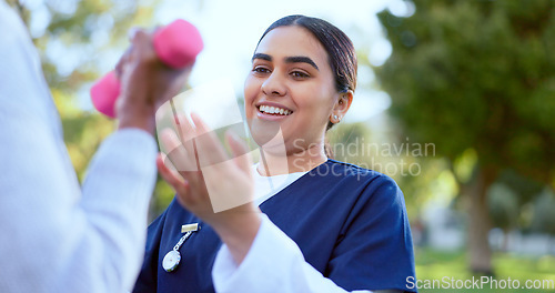 Image of Hands, nurse and dumbbell outdoor for exercise, workout or fitness in a park with happiness. People, professional or caregiver with weightlifting for physiotherapy, wellness and health in nature