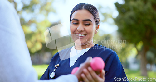 Image of Hands, caregiver and dumbbell in support for exercise, workout or fitness in a park with happiness. People, professional or nurse with weightlifting for physiotherapy, wellness and health outdoor