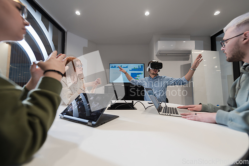 Image of A diverse group of businessmen collaborates and tests a new virtual reality technology, wearing virtual glasses, showcasing innovation and creativity in their futuristic workspace