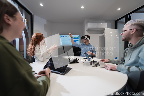 Image of A diverse group of businessmen collaborates and tests a new virtual reality technology, wearing virtual glasses, showcasing innovation and creativity in their futuristic workspace