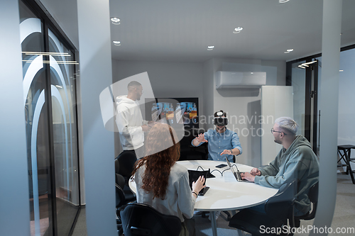 Image of A diverse group of businessmen collaborates and tests a new virtual reality technology, wearing virtual glasses, showcasing innovation and creativity in their futuristic workspace