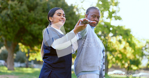 Image of Elderly, woman and caregiver with arm stretching for exercise, workout or fitness in a park with smile. People, professional or nurse with activity for physiotherapy, wellness and health in nature