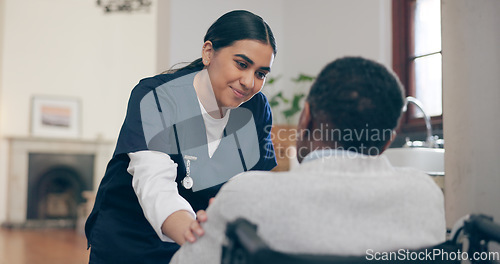 Image of Consultation, healthcare and nurse with patient in a wheelchair for discussion at nursing home. Medical career, conversation and young female caregiver talking to woman with disability in her house.