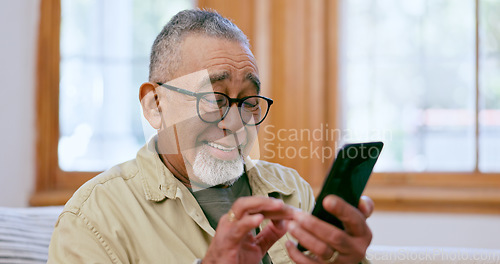 Image of Phone, smile and social media with a senior man on a sofa in the living room of his home for retirement. Relax, app and a happy elderly person in an apartment for communication on his mobile