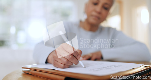 Image of Senior woman, sign and writing with documents, paperwork and application for life insurance policy. Person, hand and checklist for compliance, investment or will in retirement with signature in home