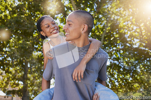 Image of Love, tree leaf and couple hug while bonding, having fun and enjoy romantic quality time together in nature park date. Peace freedom, piggyback ride and happy black woman and gen z man play outdoor