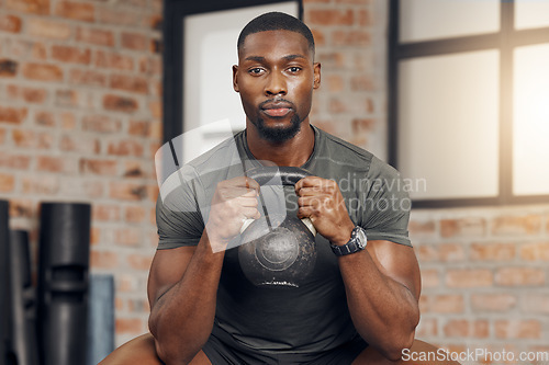 Image of Fitness, gym and portrait of a black man with a kettlebell for strength training for wellness. Motivation, sports and strong African athlete doing a exercise or workout with weights at a health club