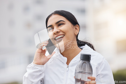 Image of Woman, phone call and fitness to relax, with water bottle and smile outdoor, exercise and conversation on break. Smartphone, connect and fresh female workout, talking and happy to rest and wellness.