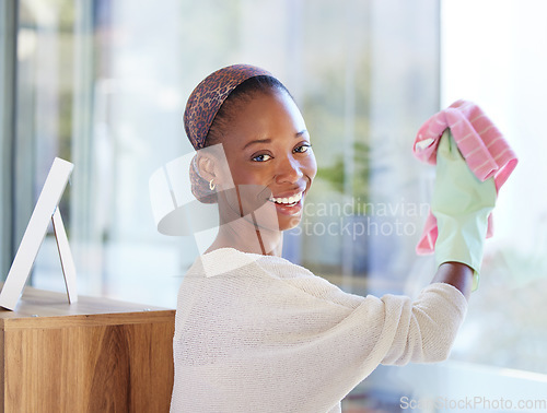 Image of Portrait, black woman and cleaning glass in home with smile for hygiene, fresh or wipe clear with cloth. African American female, lady and cleaner being happy, domestic and window dusting and chores