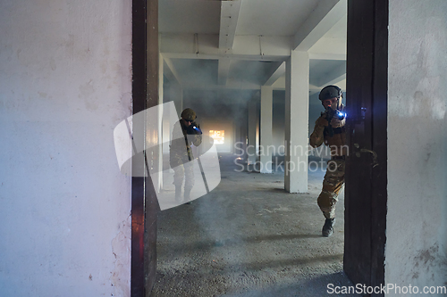 Image of A group of professional soldiers bravely executes a dangerous rescue mission, surrounded by fire in a perilous building.