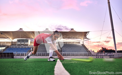 Image of Sports, hockey and woman in stadium training for game, match or competition. Fitness, healthcare and hockey player outdoors on grass field practicing, exercise or workout with ball and hockey stick.