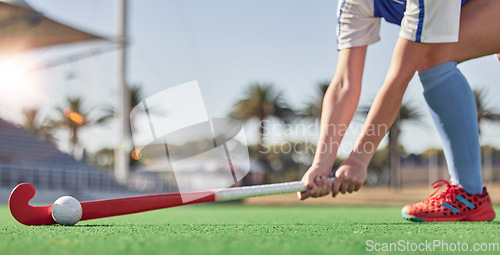 Image of Hockey, sports and woman athlete on a turf field with a stick and ball for exercise, training and competition performance to win. Hands of hockey player on grass for sport goal, fitness and health