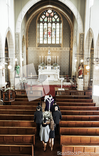 Image of Funeral, church and people walking together to carry a coffin after a death or loss while inside for memorial service. Family, friends or community feeling sad, grief and mourning at Christian event