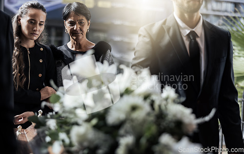 Image of Funeral, coffin and family or friends at death, mourning and church burial event sad together. Depression, grief and christian religion gathering of people and women with support with flowers