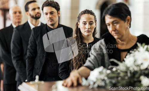 Image of Funeral, goodbye and family with a coffin in a church during a service in death, mourning and grief. Respect, greeting and sad people in a row with a casket in a cathedral for a burial or memorial