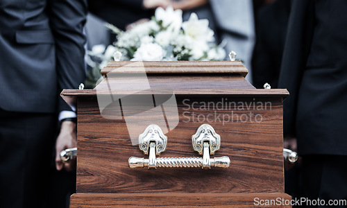 Image of Coffin, people and funeral with death, grief and service with family carry casket to grave outdoor. Rip, farewell and ceremony or event for dead person together in respect, religion and spiritual