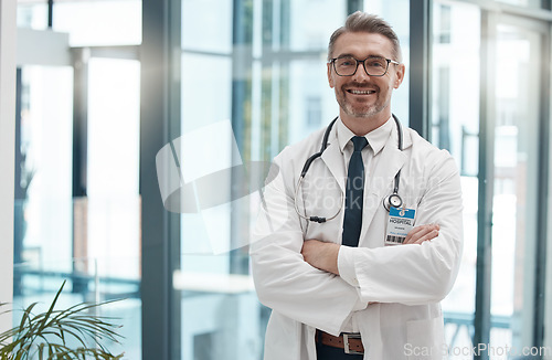 Image of Mature man, arms crossed and doctor in hospital, healthcare and wellness clinic with trust, vision or help motivation. Portrait, smile or happy consulting medical worker or surgery insurance employee