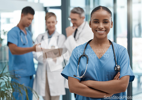 Image of Doctor, portrait or black woman nurse with vision, motivation or leadership in hospital with team. Happy medical healthcare, wellness worker with smile at work for insurance or medicine in clinic