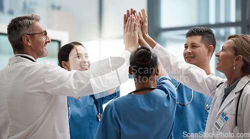Image of Hands, high five and collaboration with a team of a doctor, nurse and health professional working in the hospital. Teamwork, motivation and support with a medical group at work in a clinic for care