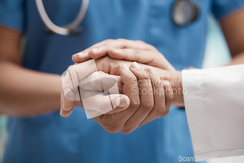 Image of Nurse with patient holding hands for help, support and healthcare advice after cancer results, medical check or sad news of death. Zoom of doctor hand sign for trust with senior clinic consultation