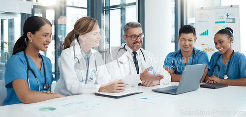 Image of Doctor, team and meeting with laptop in conference for medical discussion or consultation at the hospital. Healthcare professionals on a video call in teamwork communication on computer at the clinic