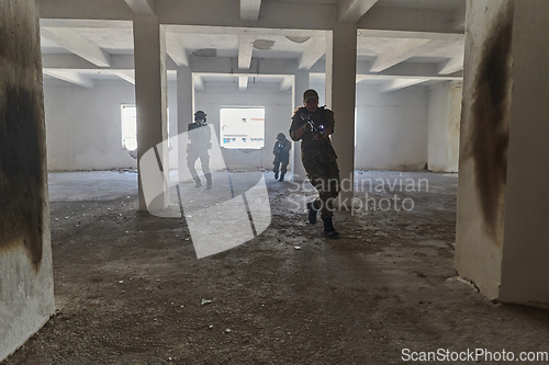 Image of A professional cameraman captures the intense moments as a group of skilled soldiers embarks on a dangerous mission inside an abandoned building, their actions filled with suspense and bravery