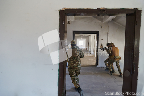 Image of A group of professional soldiers bravely executes a dangerous rescue mission, surrounded by fire in a perilous building.