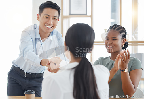 Image of Handshake, office and success with partnership deal together at corporate company meeting. Professional b2b agreement and negotiation with cheerful clapping applause in office workplace.